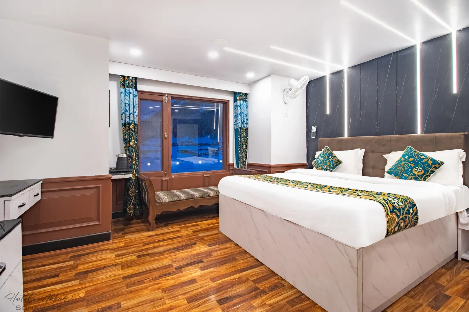 Bright modern bedroom with warm wood flooring.