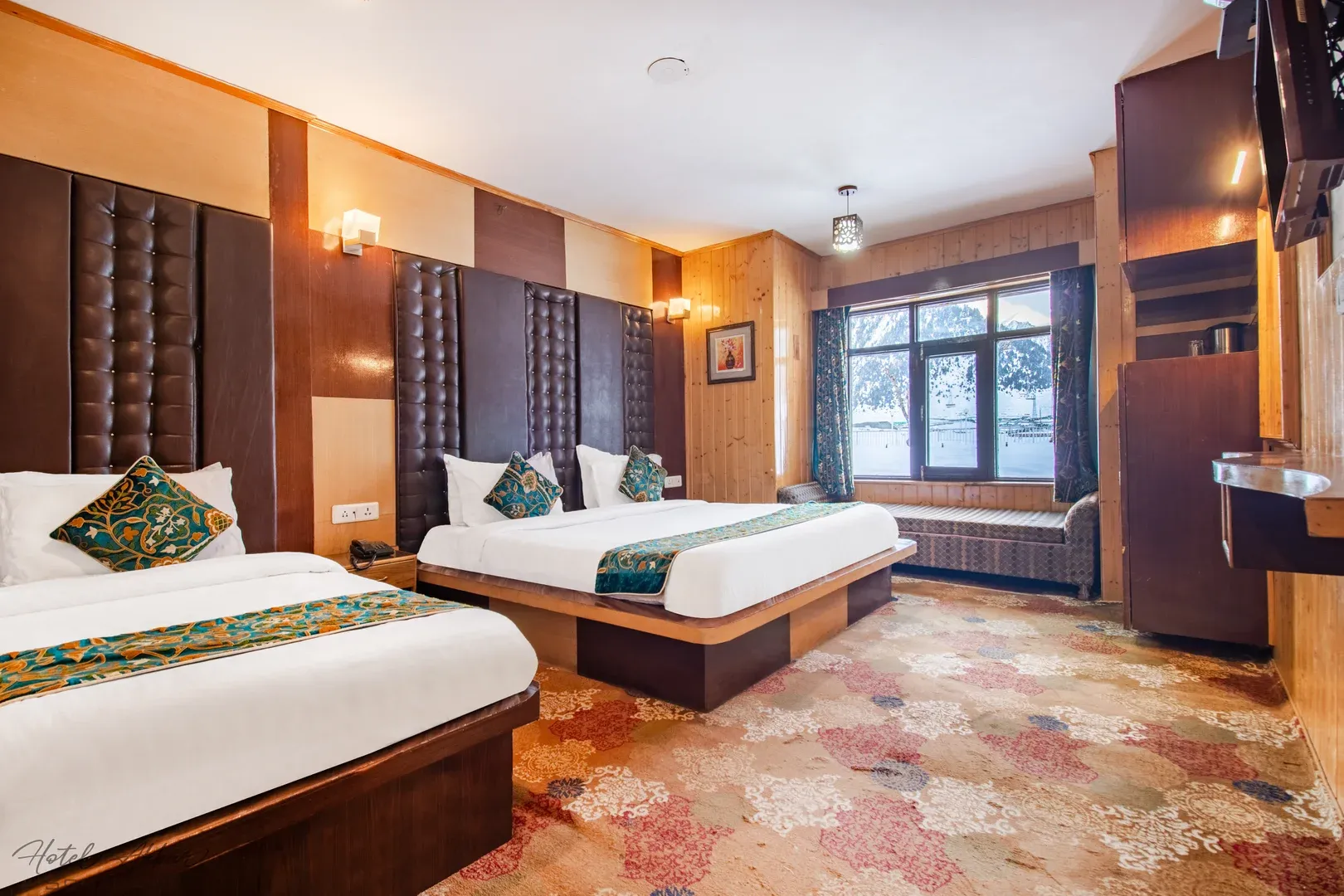 Comfortable twin beds in grand Sonmarg suite.