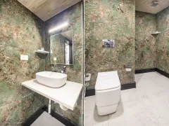 Elegant textured tiling, modern bathroom amenities.