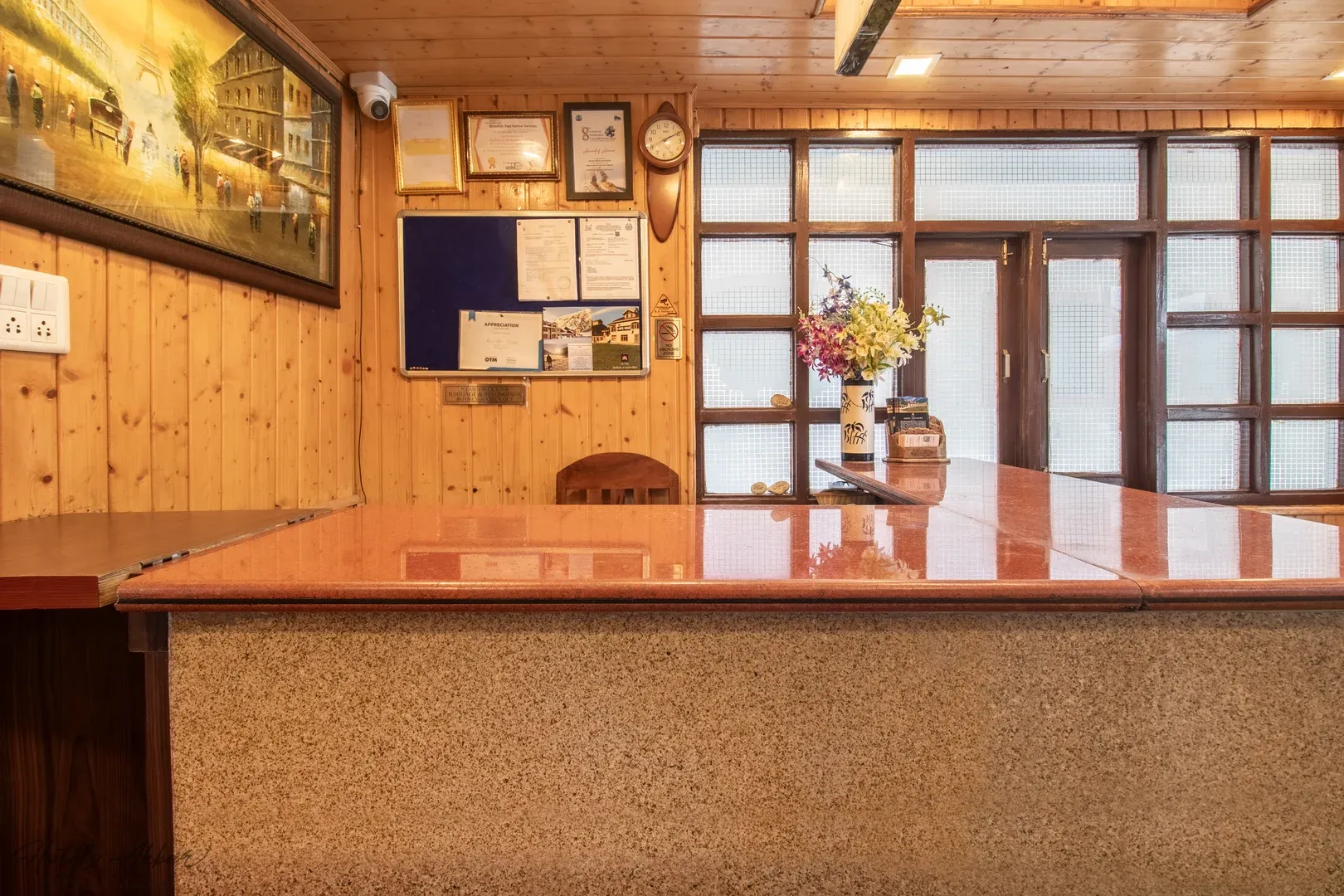 Grand wooden reception counter interior design view.