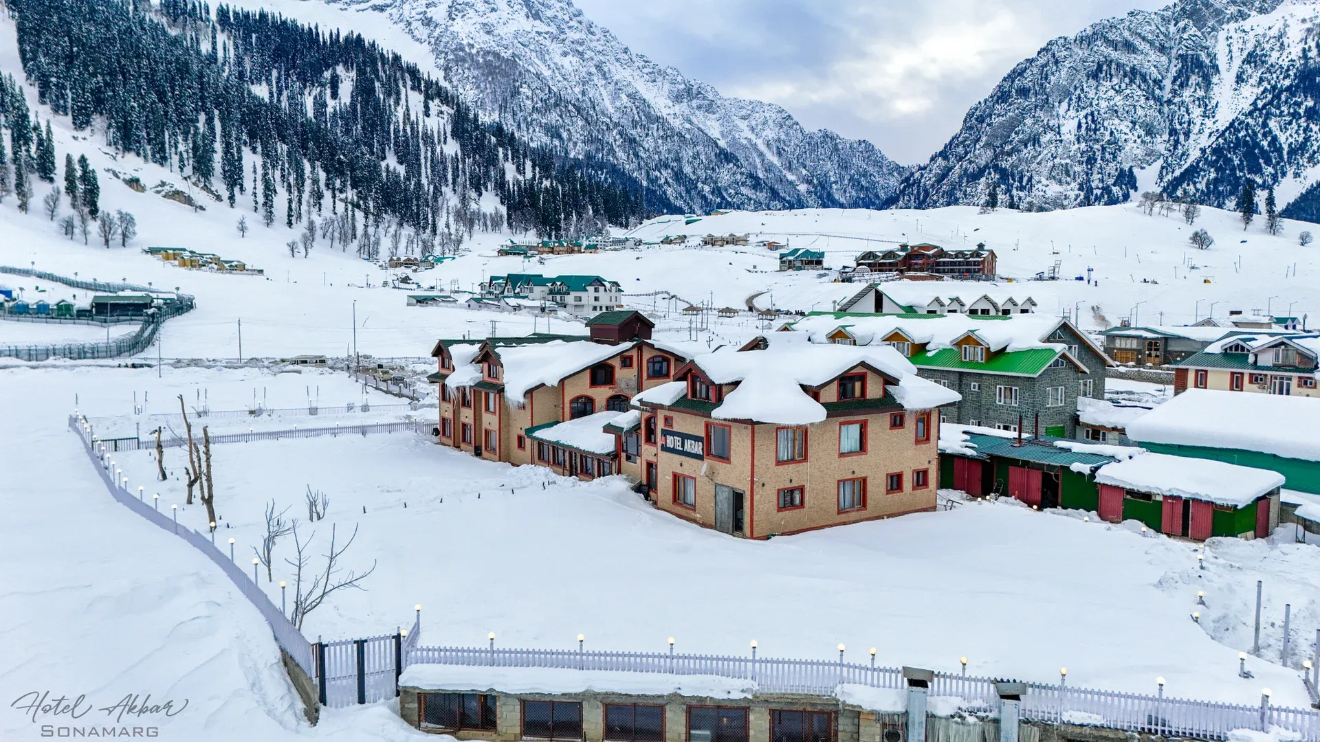 Majestic snow-covered mountain hotel valley view.
