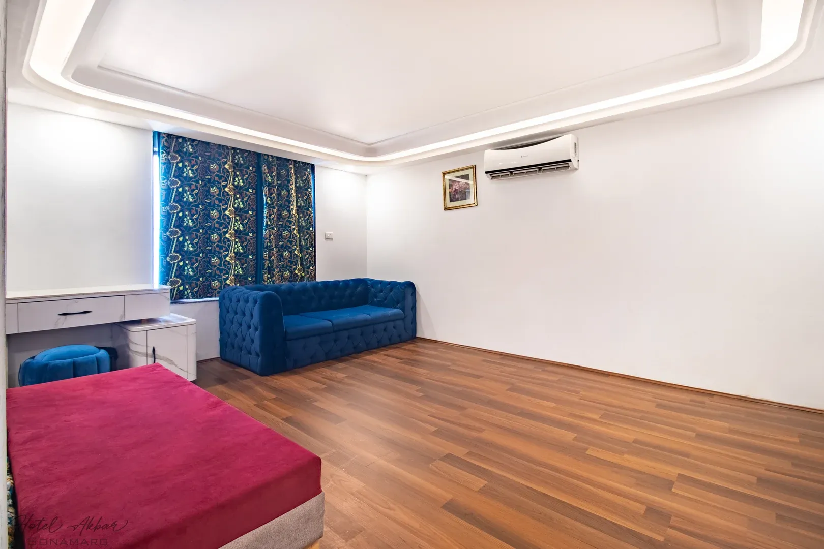 Modern hotel interior wood flooring and bedding.
