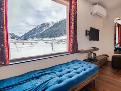 Snowy mountain panorama through hotel window.