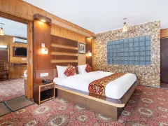 Spacious luxury bedroom featuring stone headboard accents.