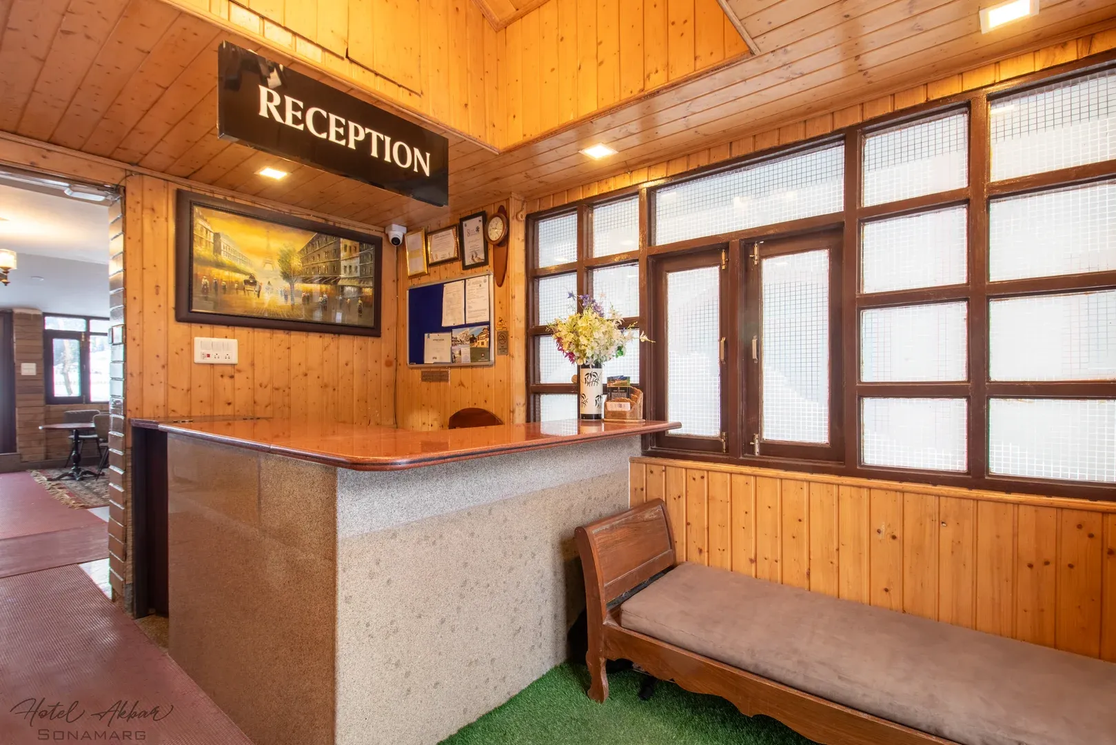 Spacious wooden reception desk lobby interior design.