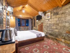 Stone-walled wooden cozy luxury bedroom.